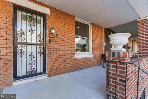 a view of an entryway with wooden floor and a cabinet