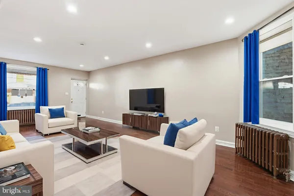a living room with furniture and a flat screen tv