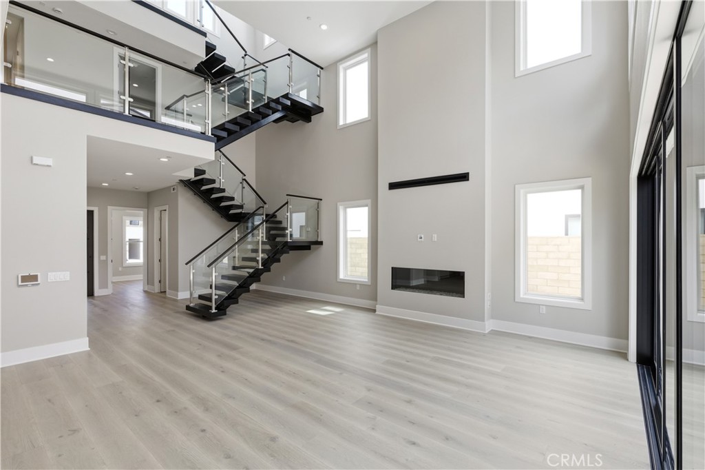 156 Apron Irvine, CA 92618 - Photo 1 of 40 a view of a livingroom with wooden floor staircase and a kitchen