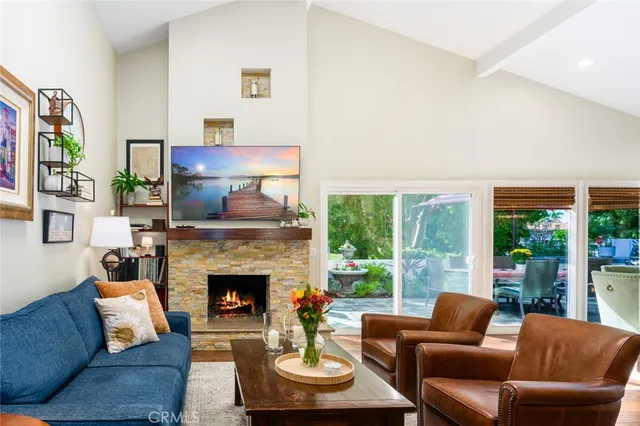 a view of a big room with wooden floor and windows
