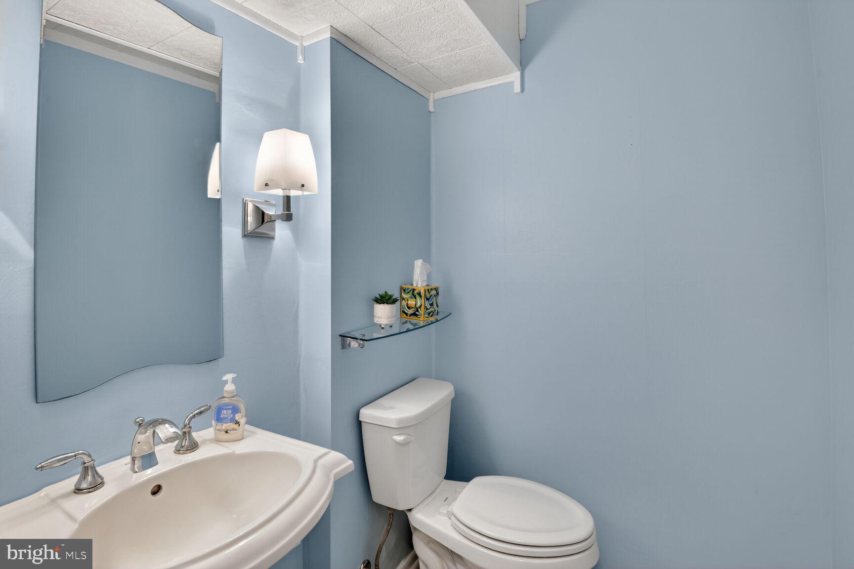 5382 View Point Court Sykesville, MD 21784 - Photo 17 of 32 a bathroom with a sink a toilet and a mirror