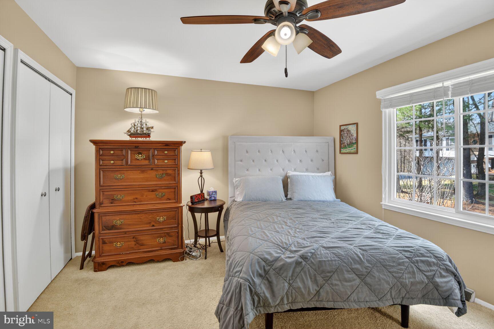 5382 View Point Court Sykesville, MD 21784 - Photo 21 of 32 a bedroom with a bed and a chandelier