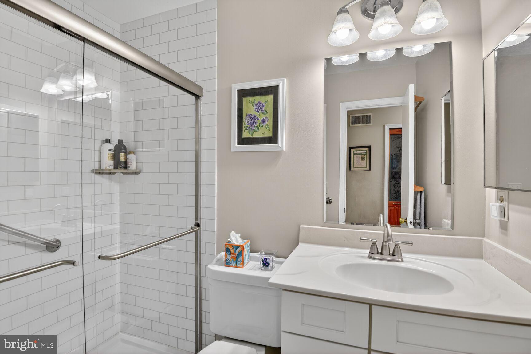 5382 View Point Court Sykesville, MD 21784 - Photo 25 of 32 a bathroom with a sink vanity and a mirror