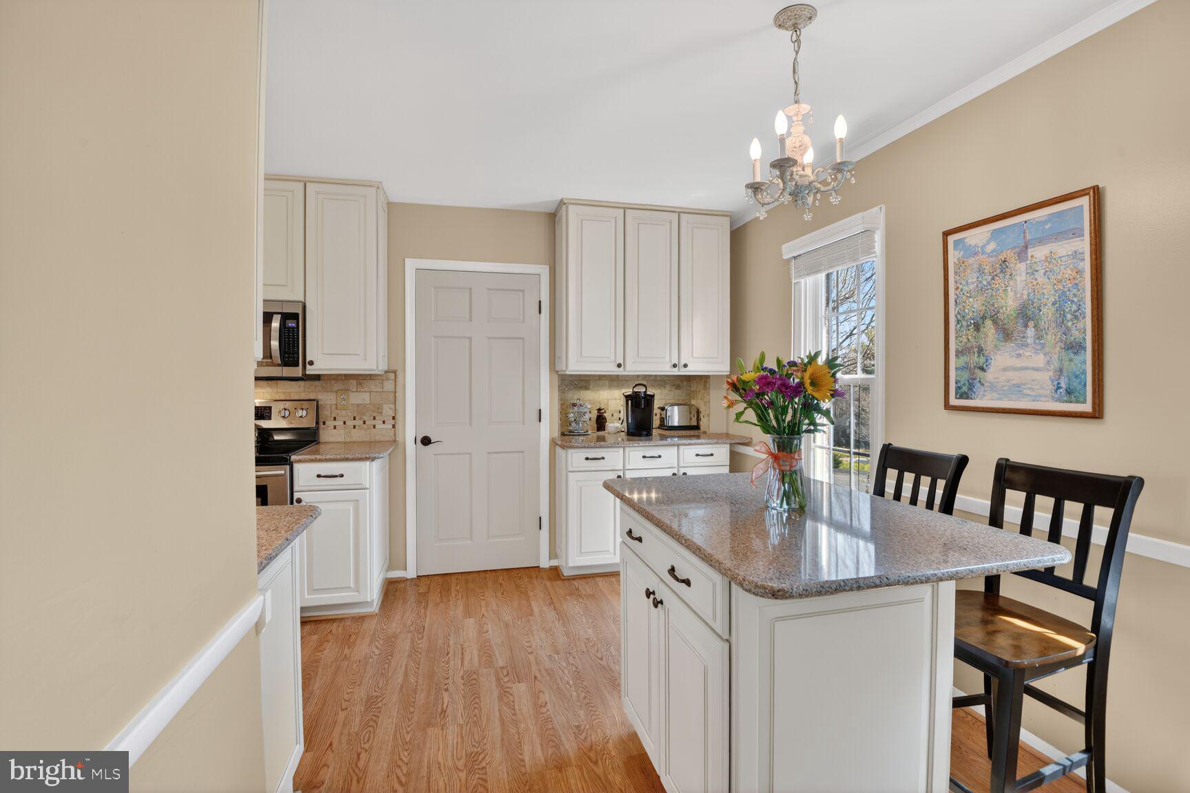 5382 View Point Court Sykesville, MD 21784 - Photo 3 of 32 a kitchen with stainless steel appliances granite countertop a refrigerator a stove a sink dishwasher and white cabinets with wooden floor