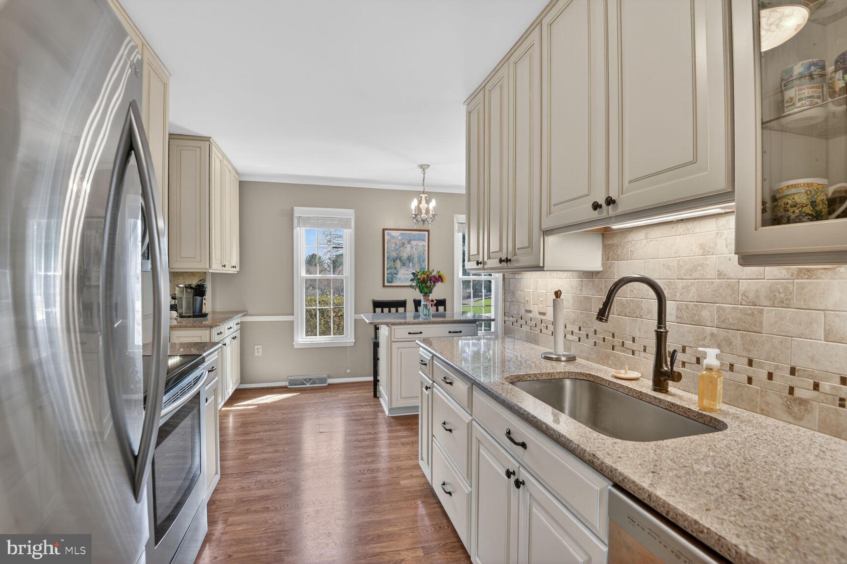 5382 View Point Court Sykesville, MD 21784 - Photo 4 of 32 a kitchen with stainless steel appliances granite countertop a sink refrigerator and cabinets