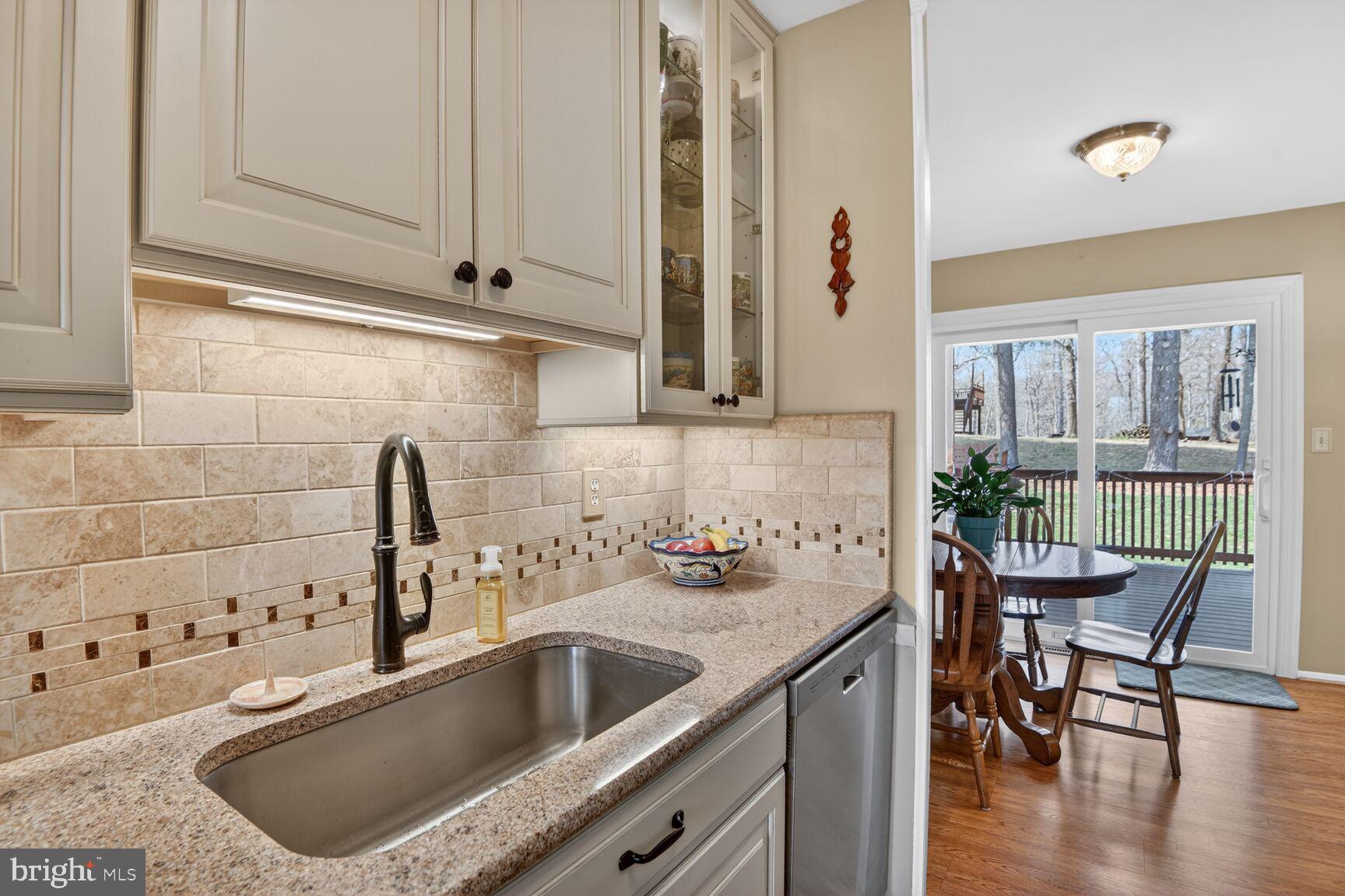 5382 View Point Court Sykesville, MD 21784 - Photo 5 of 32 a kitchen with a sink cabinets and wooden floor