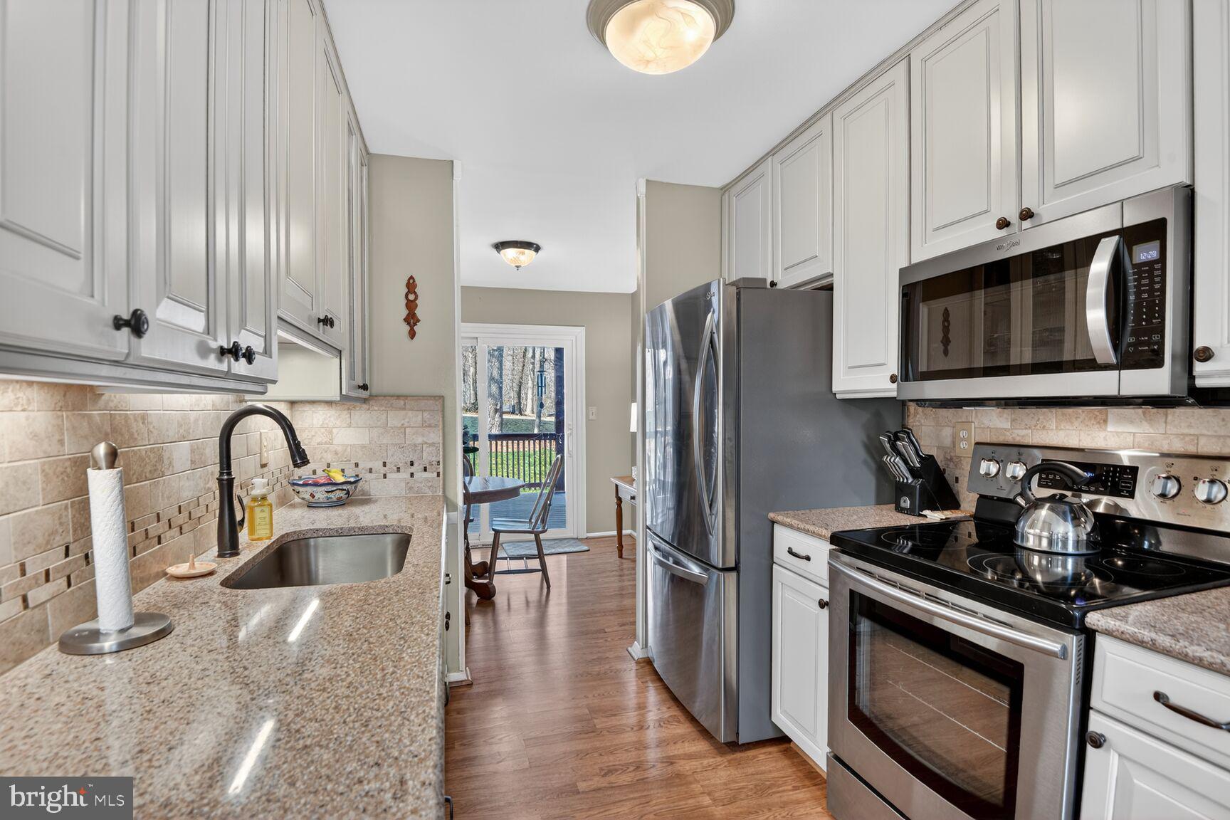 5382 View Point Court Sykesville, MD 21784 - Photo 6 of 32 a kitchen with stainless steel appliances granite countertop a refrigerator stove top oven and sink