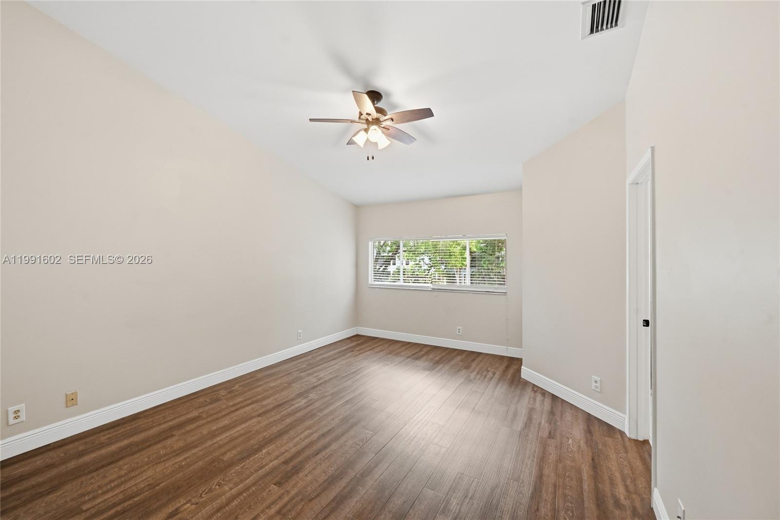 6215 Old Court Road, Unit 505 Boca Raton, FL 33433 - Photo 22 of 36 an empty room with wooden floor chandelier fan and windows