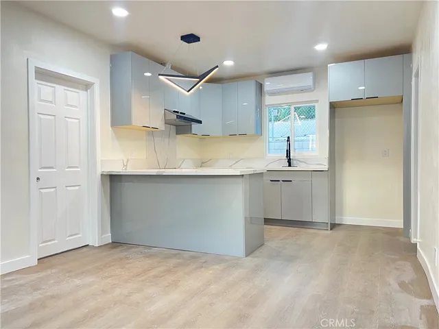 a kitchen with kitchen island a sink stainless steel appliances and cabinets