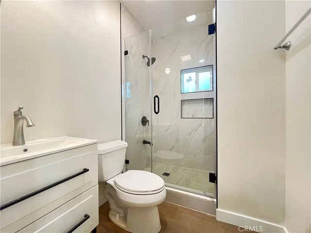 a bathroom with a toilet a sink and shower