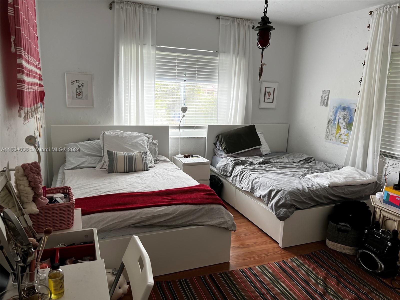 454 Southwest 25th Road Miami, FL 33129 - Photo 17 of 33 a bedroom with a bed and wooden floor