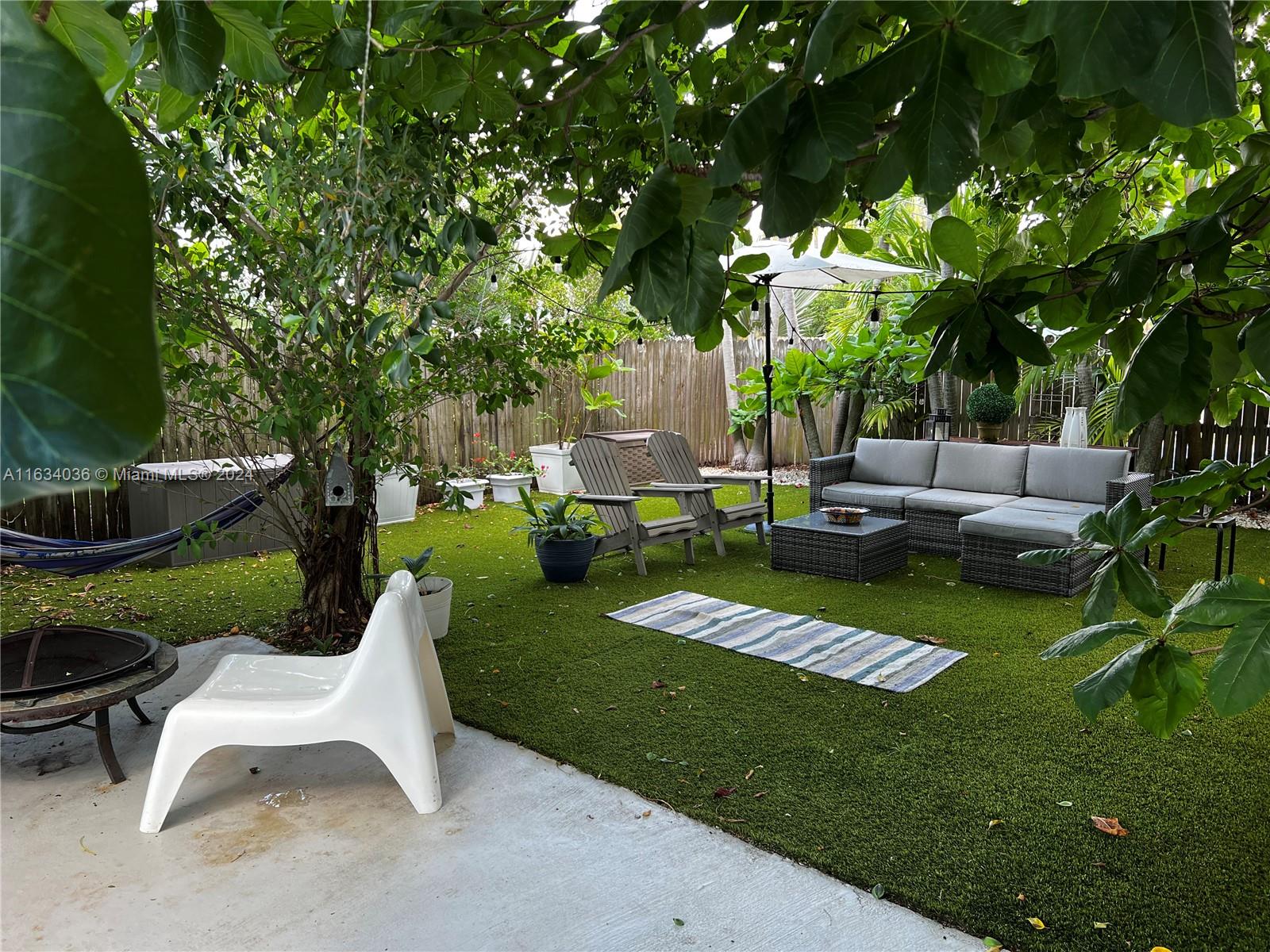 454 Southwest 25th Road Miami, FL 33129 - Photo 27 of 33 a view of a garden with couches and potted plants