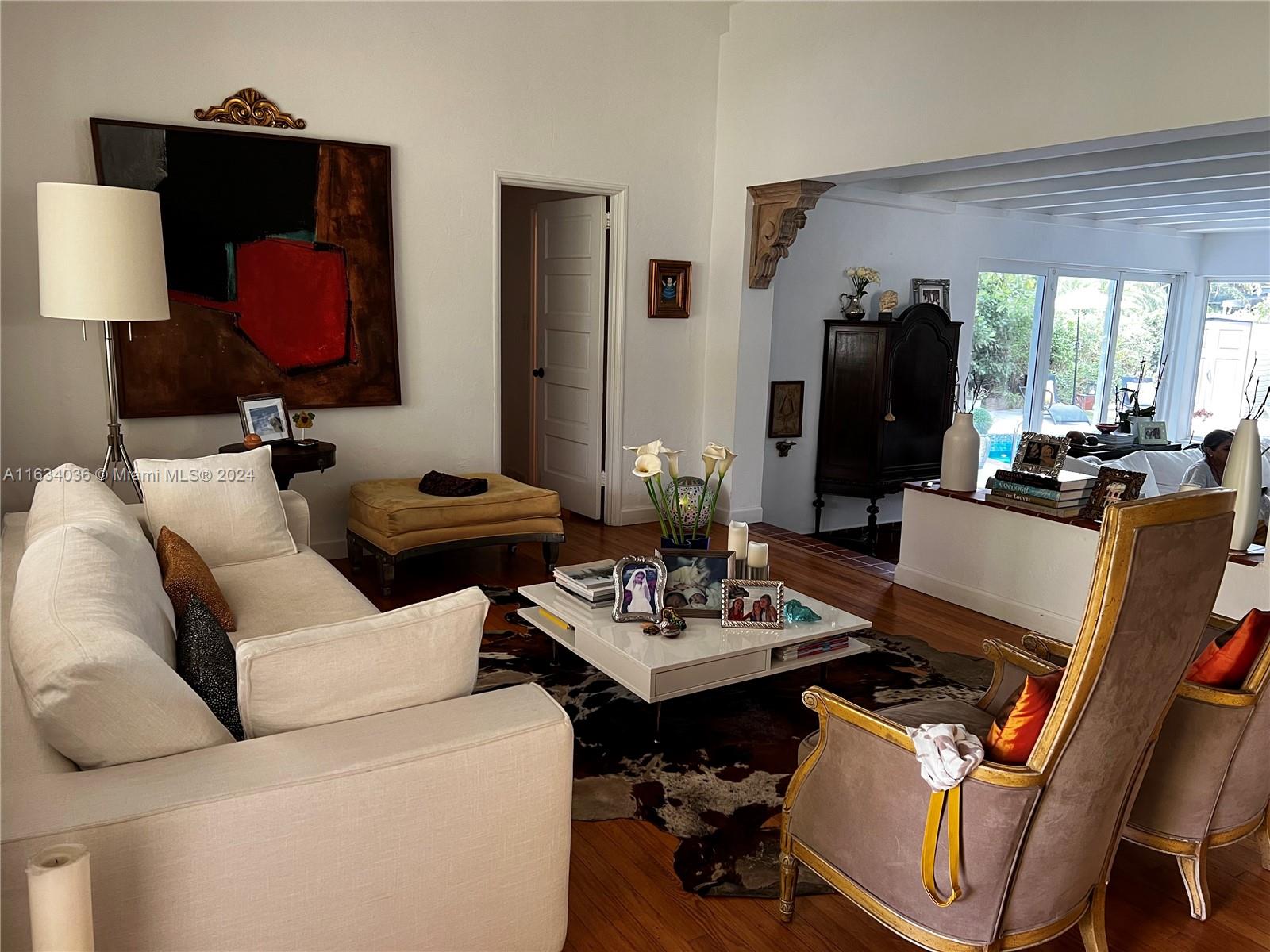 454 Southwest 25th Road Miami, FL 33129 - Photo 5 of 33 a living room with furniture a flat screen tv and a table