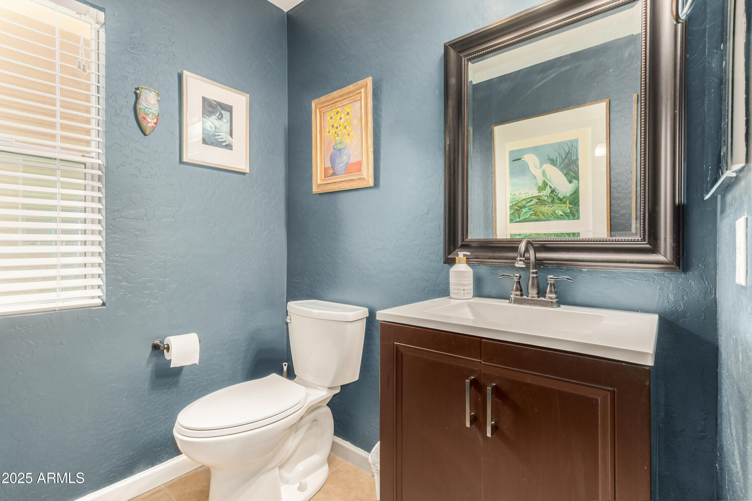 4586 East Silverbell Road San Tan Valley, AZ 85143 - Photo 12 of 32 a bathroom with a toilet sink and mirror