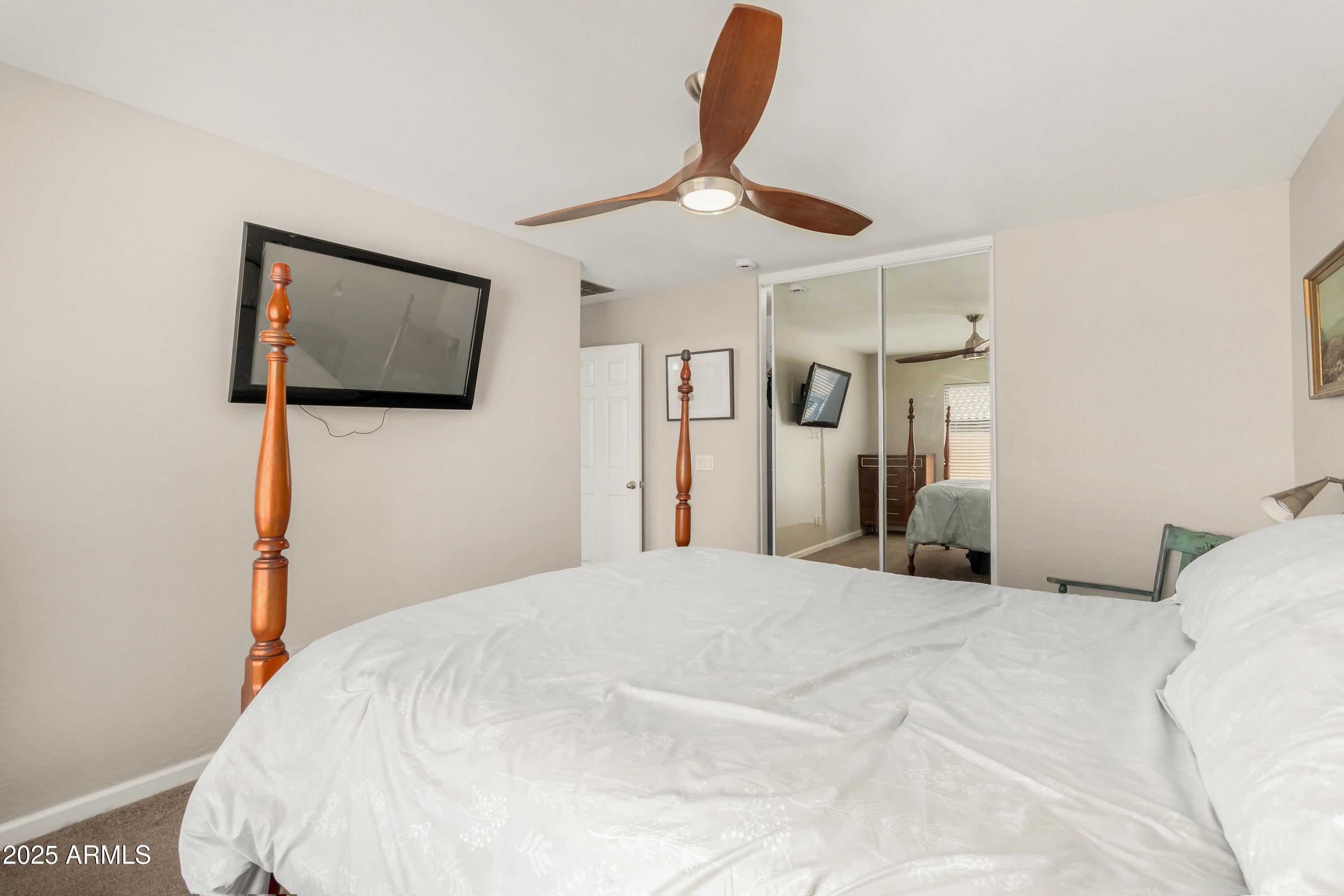 4586 East Silverbell Road San Tan Valley, AZ 85143 - Photo 15 of 32 a bedroom with a bed and a painting on the wall