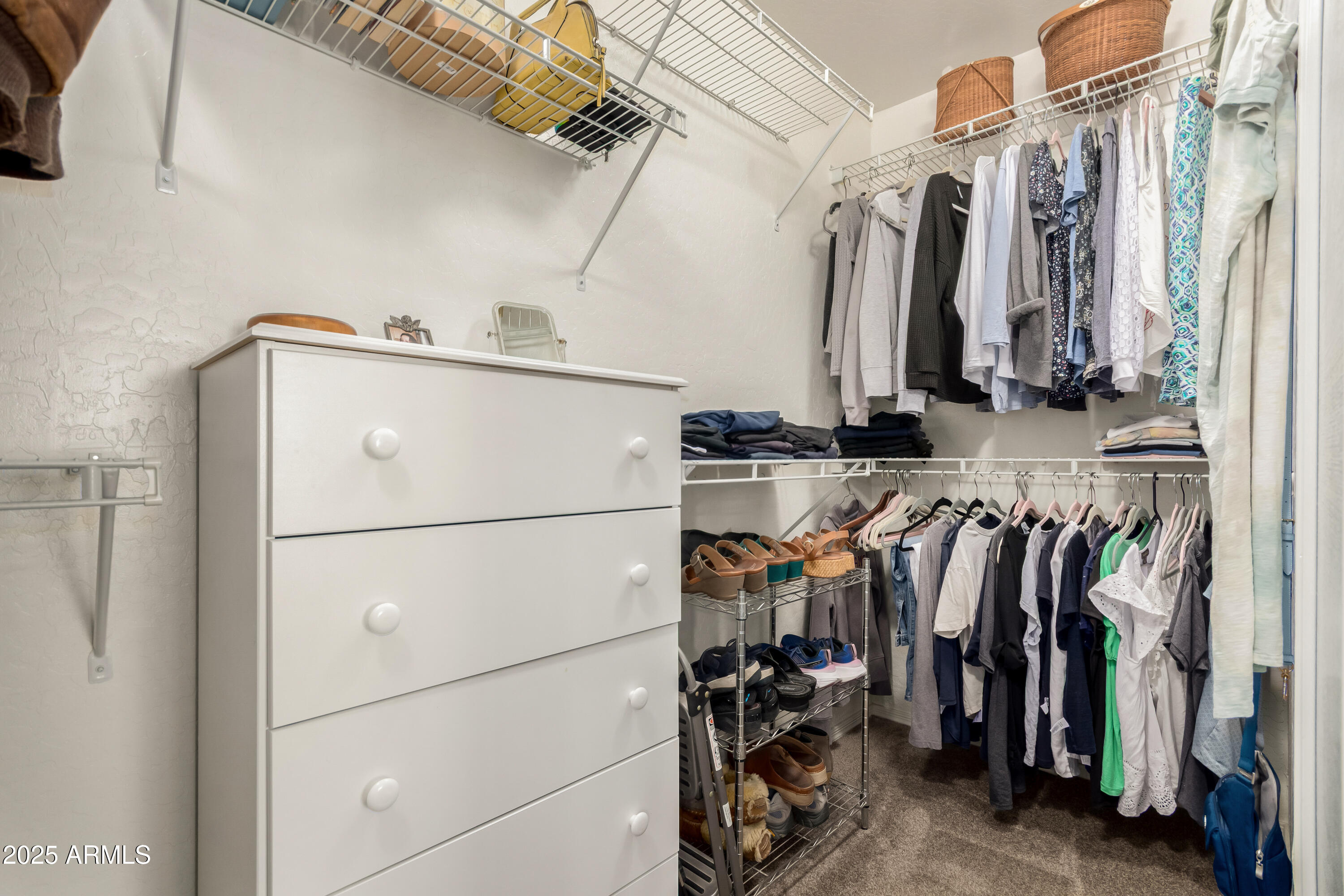 4586 East Silverbell Road San Tan Valley, AZ 85143 - Photo 17 of 32 a view of walk in closet with clothes and shoes