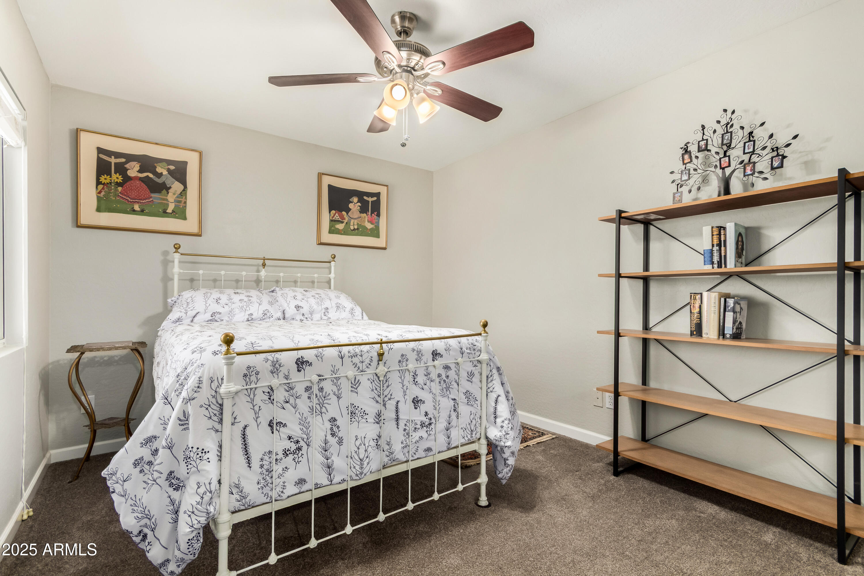 4586 East Silverbell Road San Tan Valley, AZ 85143 - Photo 18 of 32 a bedroom with a bed and a chandelier