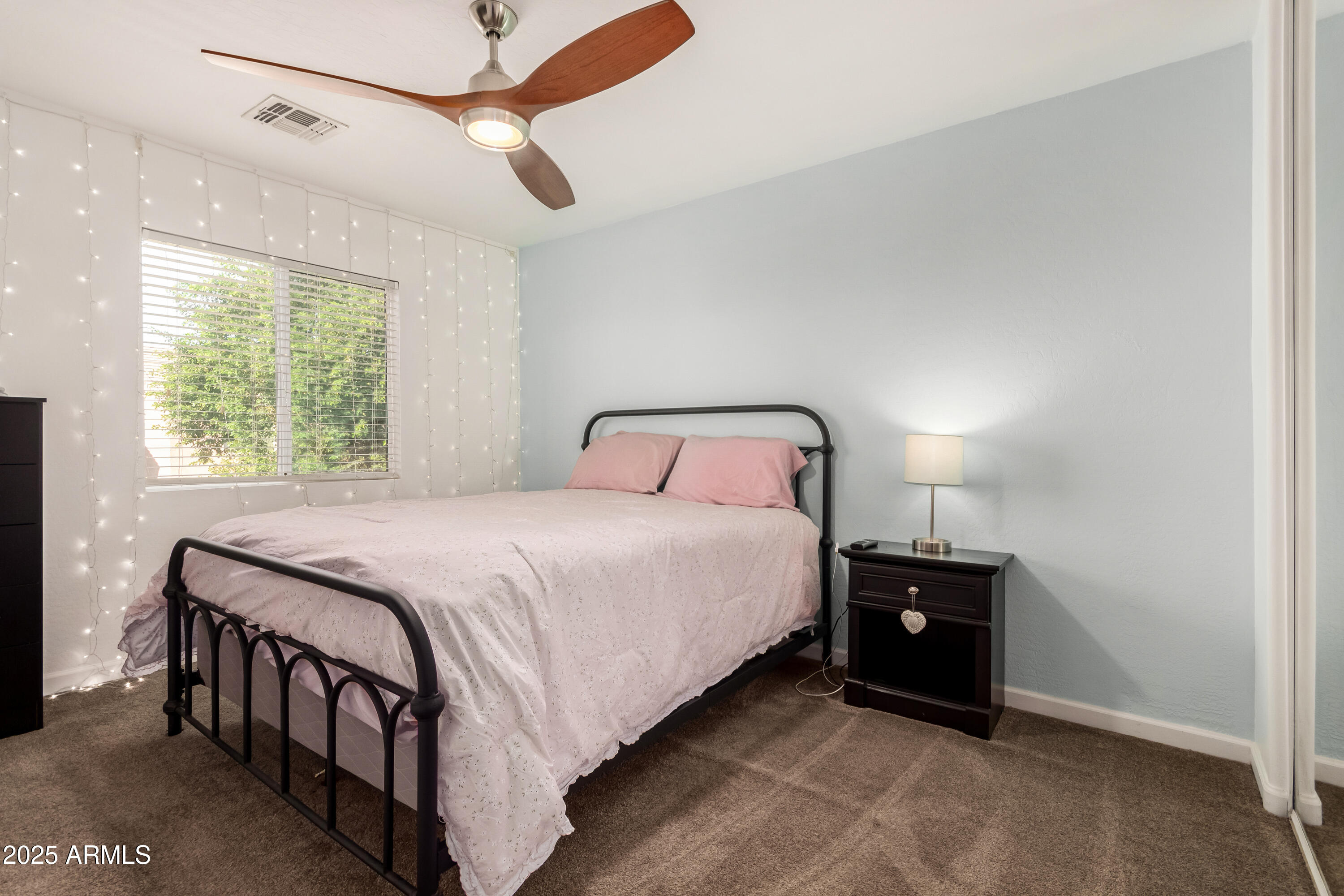 4586 East Silverbell Road San Tan Valley, AZ 85143 - Photo 20 of 32 a bedroom with a bed and a chandelier