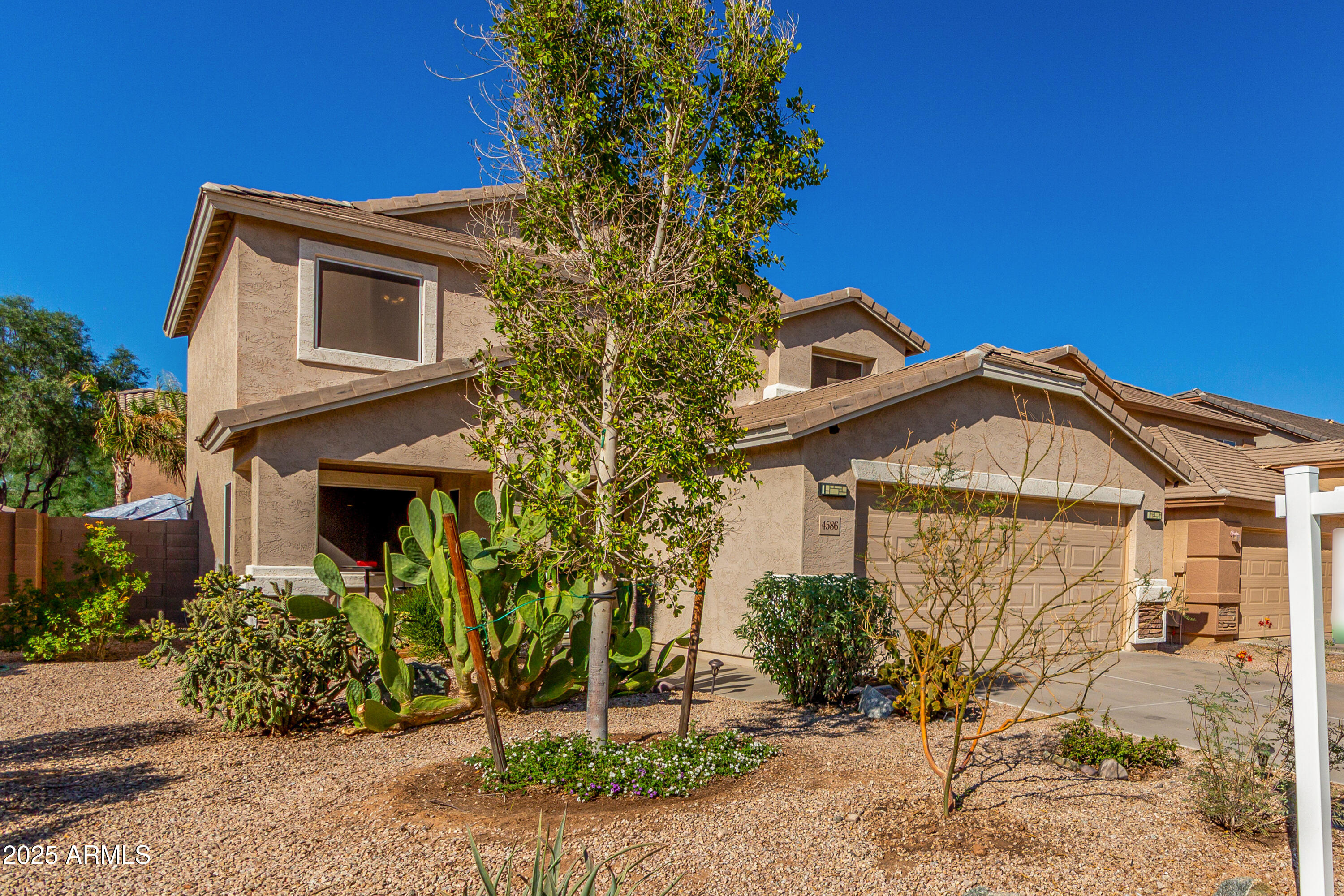 4586 East Silverbell Road San Tan Valley, AZ 85143 - Photo 2 of 32 a front view of a house with a yard