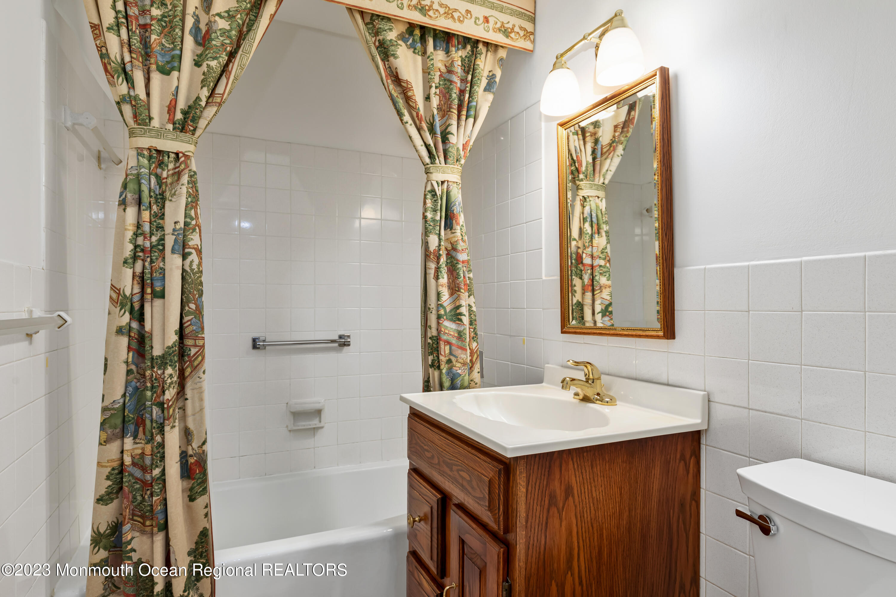 28 Riverside Avenue, Unit 2M Red Bank, NJ 07701 - Photo 11 of 31 a bathroom with a sink a mirror and a shower