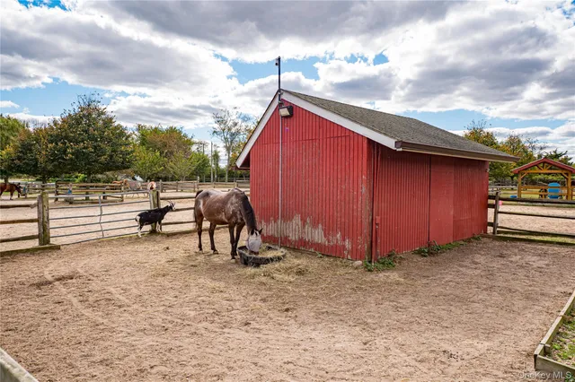 a view of backyard with wooden fence