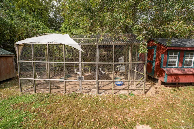 a view of a backyard with table and chairs and wooden fence