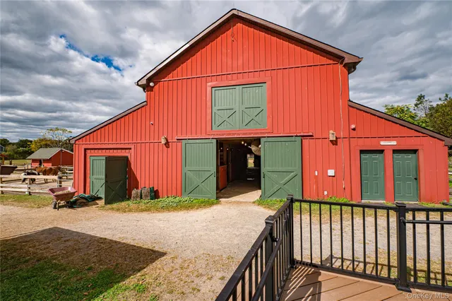 a view of house with backyard and sitting area