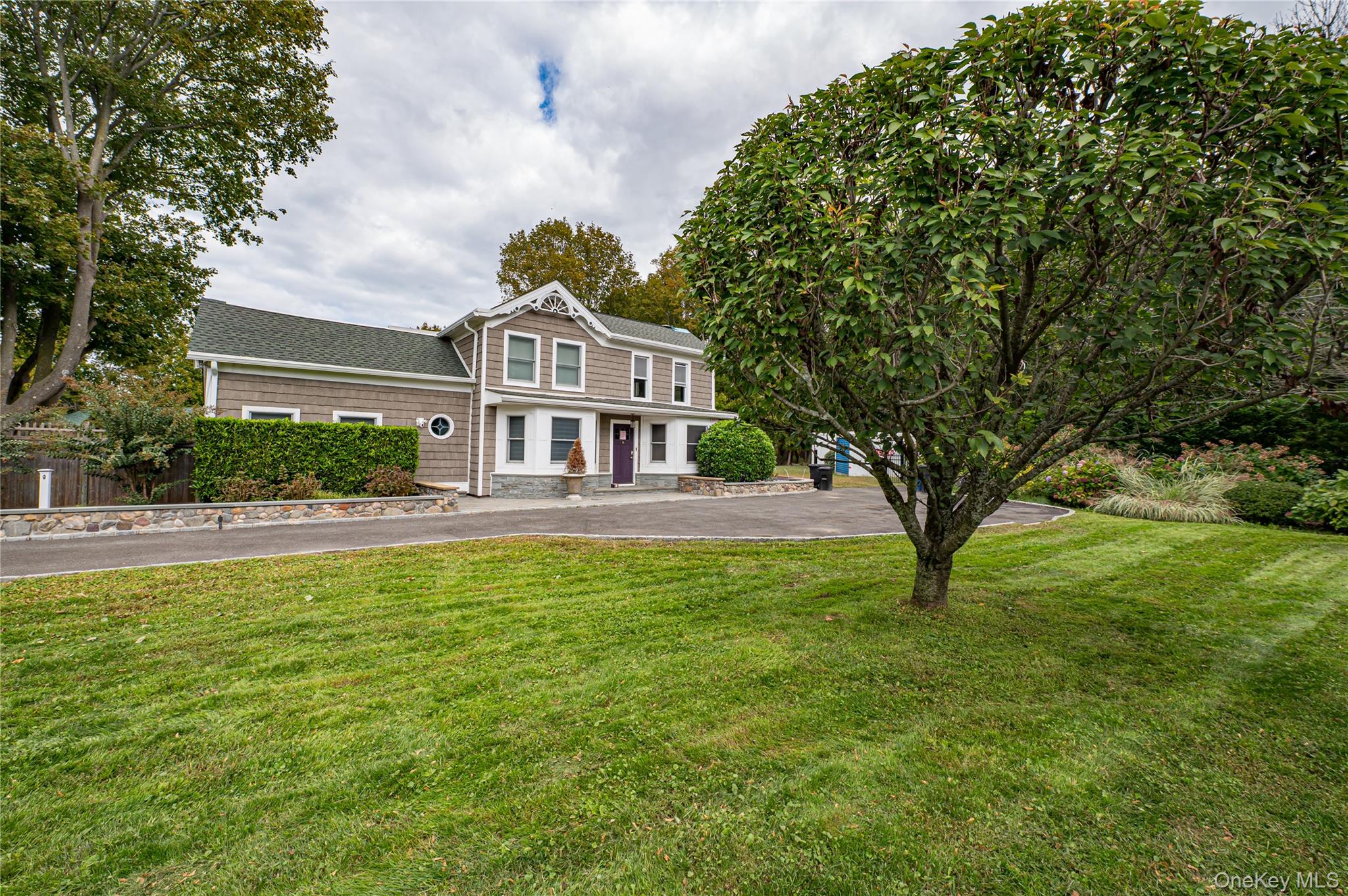 2746 Sound Avenue Riverhead, NY 11901 - Photo 5 of 44 a front view of a house with a yard
