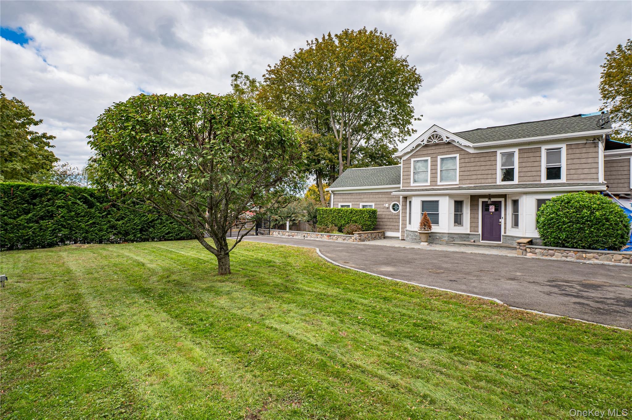 2746 Sound Avenue Riverhead, NY 11901 - Photo 6 of 44 a front view of a house with a yard