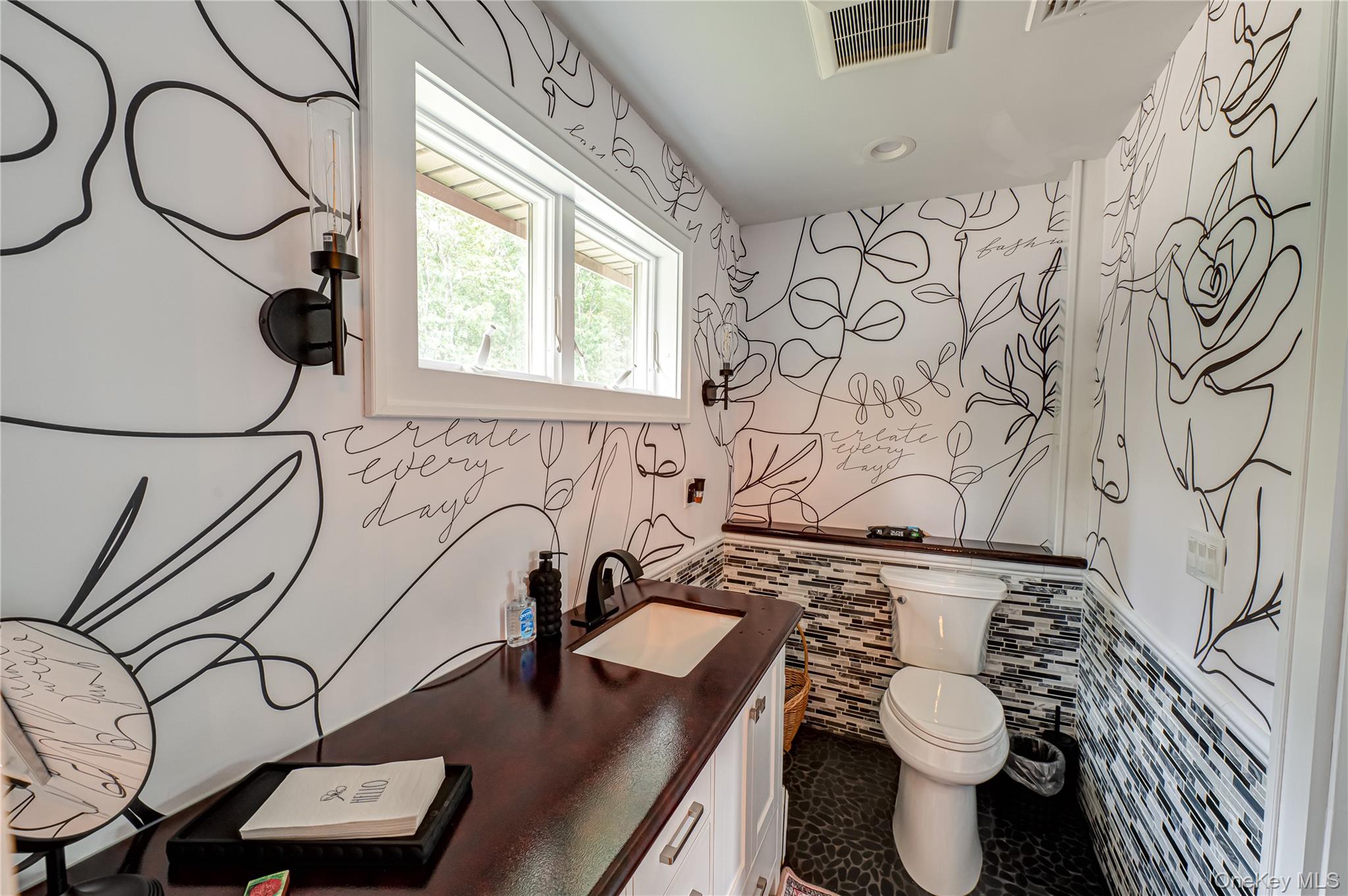 2746 Sound Avenue Riverhead, NY 11901 - Photo 10 of 44 a bathroom with a toilet sink and mirror