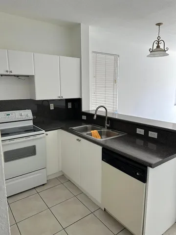 a kitchen with a sink and a stove