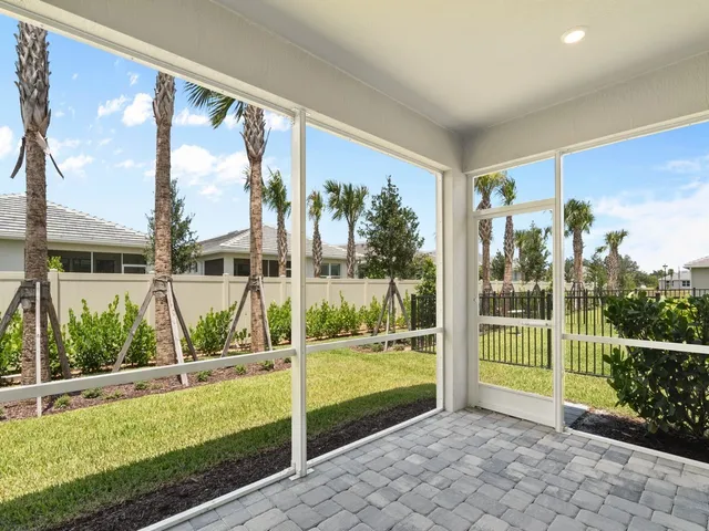 a view of a porch with a floor to ceiling window and a yard