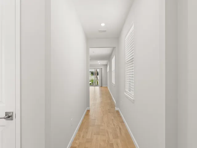 a view of a hallway with wooden floor