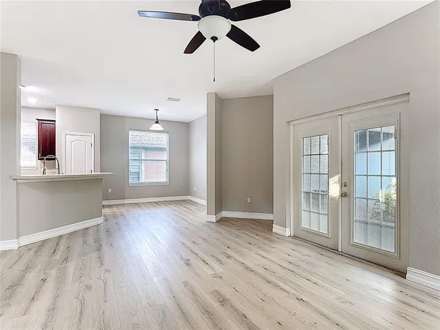 a kitchen with stainless steel appliances granite countertop a refrigerator a stove a sink dishwasher and a oven with wooden floors