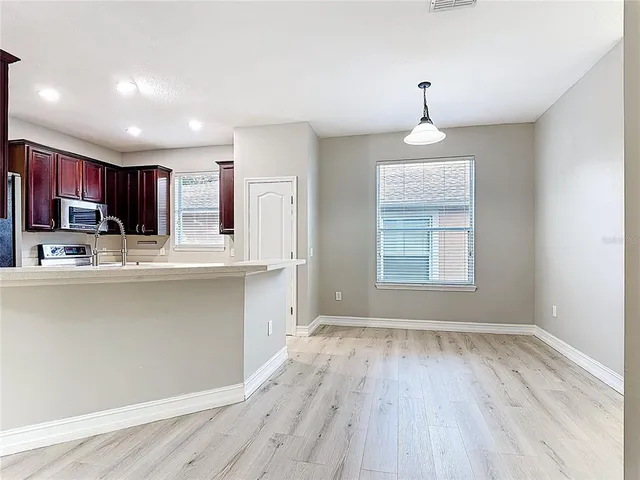 a kitchen with granite countertop cabinets stainless steel appliances and a window