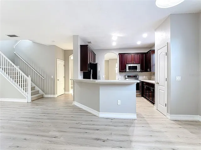 a kitchen with a sink and refrigerator
