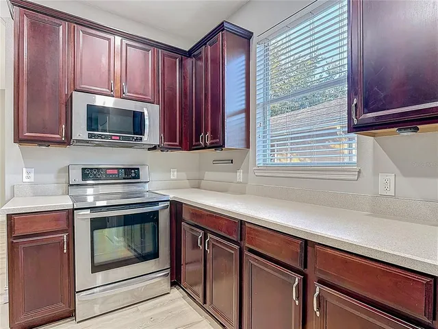 a kitchen with a refrigerator and a sink