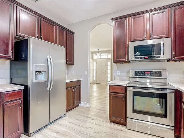a bathroom with a toilet sink vanity and mirror