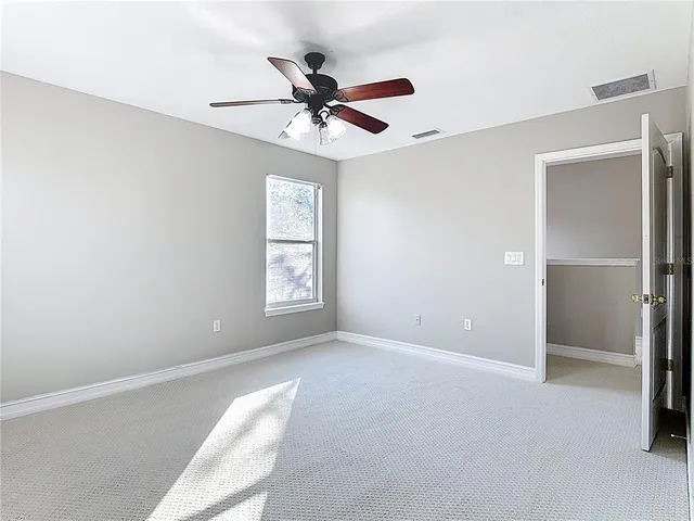 a view of a livingroom with a ceiling fan and window