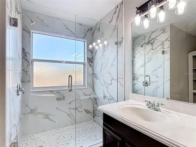 a view of a hallway with windows and stairs