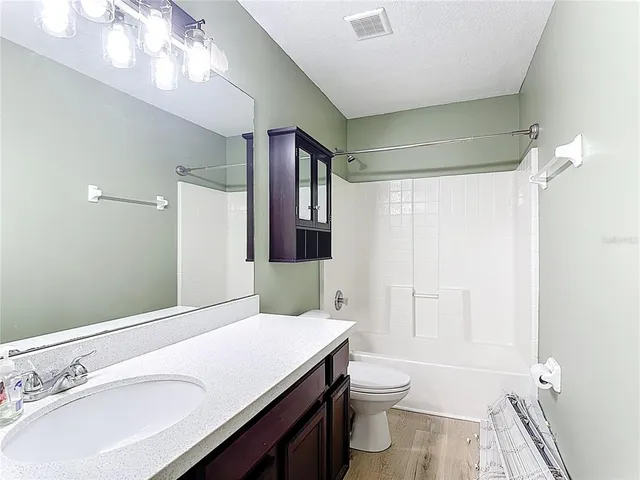 a view of a room with a potted plant and floor to ceiling window