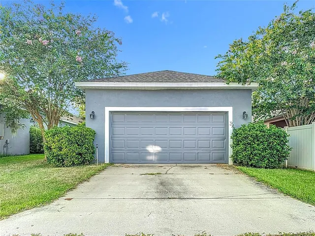 an aerial view of residential houses with outdoor space and ocean view