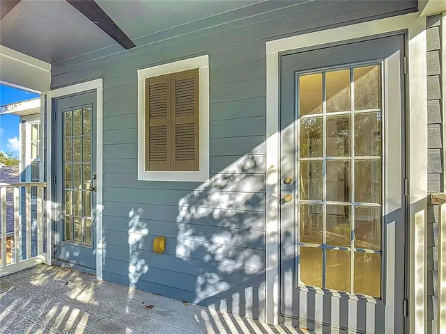 a view of a door with a glass door and wooden floor