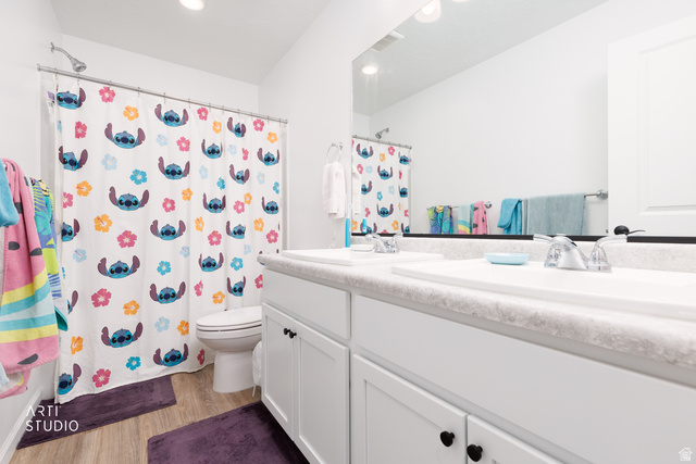 540 Lefty Lane Tooele, UT 84074 - Photo 20 of 48 Full bathroom featuring double vanity, light wood-style flooring, curtained shower, and recessed lighting