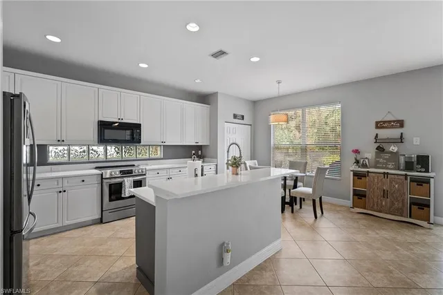 a large white kitchen with appliances and cabinets