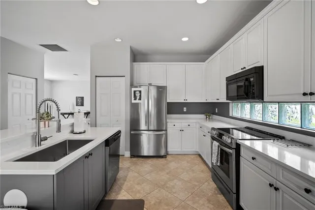 a kitchen with stainless steel appliances a refrigerator sink and microwave