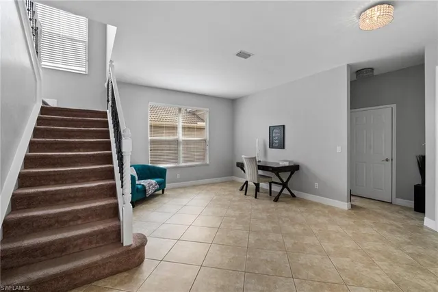 a view of a livingroom with furniture and a window
