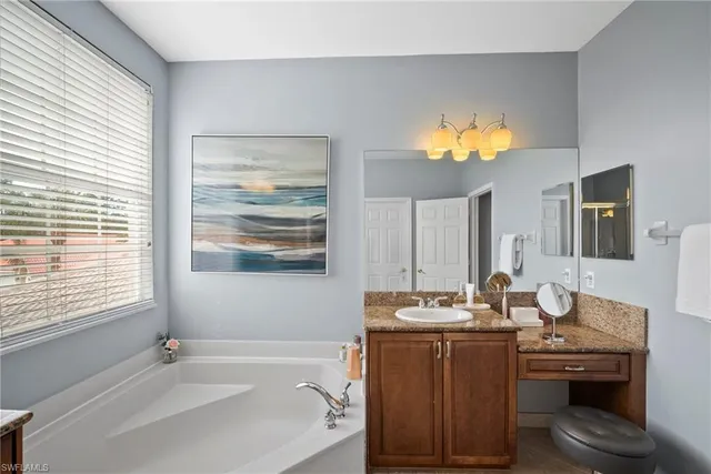 a bathroom with a sink a vanity and a mirror