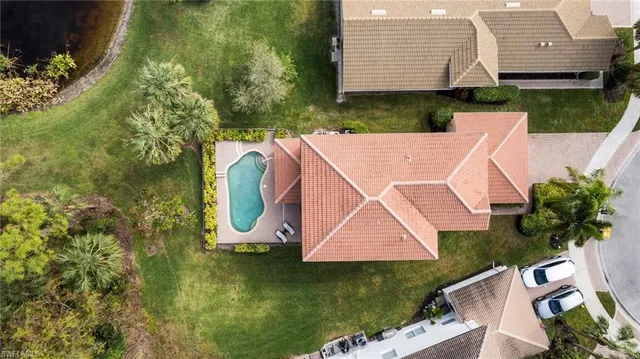 an aerial view of a house with garden space and trees