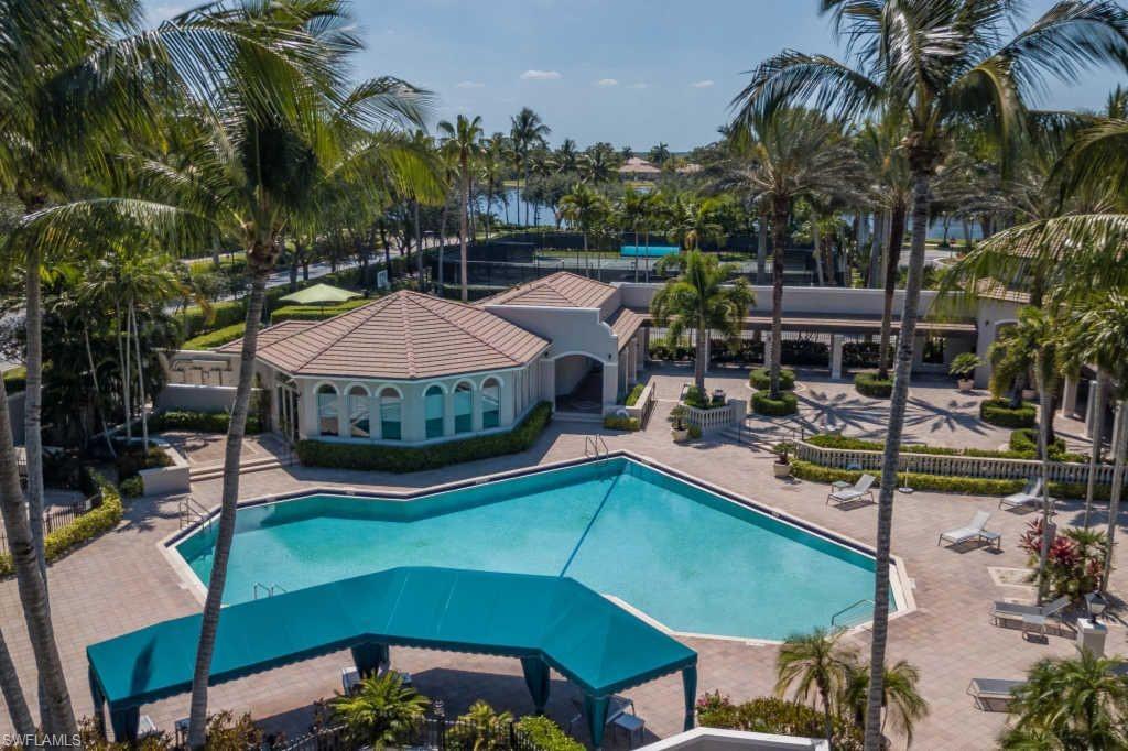 1384 Areca Cove Naples, FL 34119 - Photo 48 of 49 a view of a swimming pool with a patio and a garden